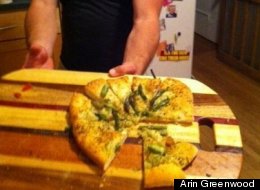 Feastly co-founder Noah Karesh holds a flatbread being served to guests.