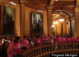 Protesters of a bill that would restrict abortion access chant inside the chamber of the state House of Representatives in Lansing, Michigan.