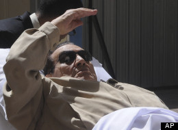 Egypt's ex-President Hosni Mubarak lays on a gurney as he arrives at the police academy courthouse in Cairo, Egypt, Saturday, June 2, 2012. (AP Photo)