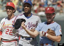 Philadelphia Phillies Mike Schmidt (right) tugs on New York Mets right fielder Darryl Strawberry’s first baseman’s mitt as he showed up with the odd glove at on Monday, July 13, 1987 All-Star workout at Oakland Coliseum. St. Louis Cardinals Jack Clark watches at left.