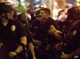 Police hold a skirmish line in downtown LA after a protest turned violent Thursday evening.