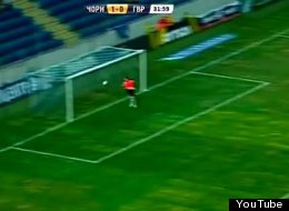 A goalkeeper for Ukrainian team Goverla attempts to deflect a back-pass from defender Evgen Eliseev.