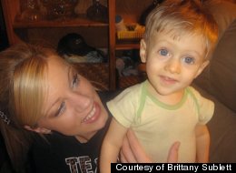 Brittany Sublett, a cousin of the Griffin family, poses on an unspecified date with Connor, 4, one of the children who was orphaned after his parents died in a car crash on July 8.
