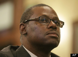 Illinois Rep. Derrick Smith, D-Chicago, listens to fellow lawmakers while attending a legislative committee hearing investigating whether Smith should be disciplined over a bribery charge at the Illinois State Capitol Thursday, May 10, 2012 in Springfield, Ill. (AP Photo/Seth Perlman)