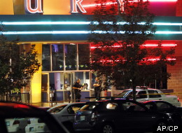 Police are pictured outside of a Century 16 movie theatre where as many as 14 people were killed and many injured at a shooting during the showing of a movie at the in Aurora, Colo., Friday, July 20, 2012. (AP Photo/Ed Andrieski)