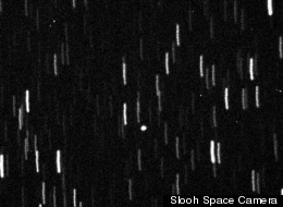 The near-Earth asteroid 2012 LZ1, which is about the size of a city block, is seen as a circular white dot in this shot taken by a telescope in the Canary Islands on June 14, 2012.
