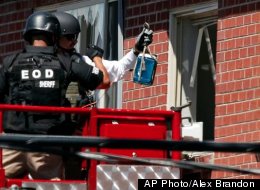 A Batman mask was found in the apartment of Colorado theater shooting suspect James Holmes. In this file photo, officials use