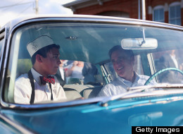 Presumptive Republican presidential candidate, former Massachusetts Gov. Mitt Romney sits in a 1961 Rambler with car owner, Michael Scheib, on June 17 in Troy, Ohio. (Photo by Joe Raedle/Getty Images)