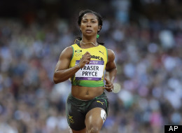 FILE: Jamaica's Shelly-Ann Fraser-Pryce, left, and Trinidad's Semoy Hackett go to cross the finish line in a women's 100-meter heat during the athletics in the Olympic Stadium at the 2012 Summer Olympics, London, Friday, Aug. 3, 2012. (AP Photo/Anja Niedringhaus)