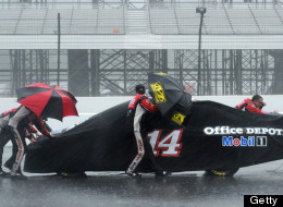 LONG POND, PA - AUGUST 05: Crew members push the #14 Office Depot Back to School Chevrolet, driven by Tony Stewart, back to the garage as rain falls during the NASCAR Sprint Cup Series Pennsylvania 400 at Pocono Raceway on August 5, 2012 in Long Pond, Pennsylvania.