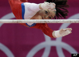 Russian gymnast Aliya Mustafina performs on the uneven bars during the Artistic Gymnastic women's qualifications at the 2012 Summer Olympics, Sunday, July 29, 2012, in London. (AP Photo/Julie Jacobson)
