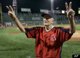 Boston Red Sox legend Johnny Pesky gestures to cheering fans as his 88th birthday is celebrated with a cake prior to their baseball game against the Minnesota Twins at Fenway Park in Boston Thursday, Sept. 27, 2007.