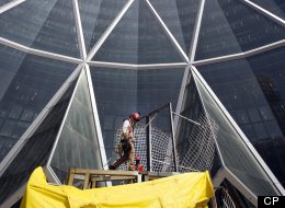 Workers put final touches to the main entrance outside the Bow Building in downtown Calgary, Alberta. (CP)