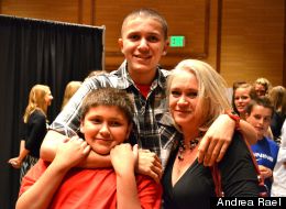 Yousef Gharbi, 16, puts his arms around his little brother and his mom at the Inverness Hotel where a homecoming-themed fashion show was held for his benefit.