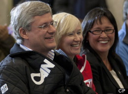 Canadian Prime Minister Stephen Harper, Laureen Harper and Minister of Health Leona Aglukkaq(right) laugh during an announcement in Cambridge Bay, Nunavut, Thursday, August 23, 2012. Aglukkaq was named as the next Chair of the Arctic Council. (THE CANADIAN PRESS/Adrian Wyld)