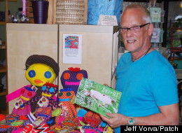 Steve English poses in his shop with the summer edition of Chicago Special Parent magazine, which features a cover story on his Changing the Face of Beauty program.