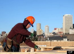 Framer Matthew Labossiere with Esquire Construction works on top of a condo development under construction on 98 Ave. in Edmonton overlooking the downtown skyline on Tuesday, March 3, 2007. Housing construction in Alberta is booming with the highest growth in the country. (Tim Smith)