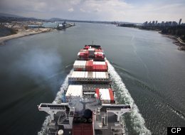 A cargo ship loaded with cargo containers bound for the Vancouver port makes its way under the Lions Gate bridge April 29, 2009. Canada’s trade deficit with the rest of the world rose to an all-time record high in July, Statistics Canada data shows. (John Lehmann/Globe and Mail)