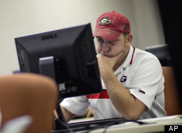 In this Aug. 22, 2012 photo, David Staten, right, of Chatsworth, Ga., files for unemployment after being laid off from a construction job in Dalton, Ga. Younger workers are having more success re-entering the labor market after layoffs during the Great Recession. (AP/David Goldman)