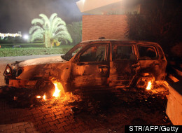 A vehicle sits smoldering in flames after being set on fire inside the US consulate compound in Benghazi late on September 11, 2012. (STR/AFP/GettyImages)