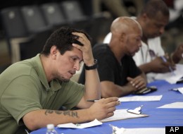In this this Tuesday, Aug. 21, 2012, photo, job seekers fill out applications at a construction job fair in New York. (AP/Seth Wenig)