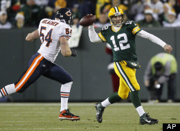 Green Bay Packers quarterback Aaron Rodgers (12) throws while being pressured by Chicago Bears middle linebacker Brian Urlacher (54) during the first half of an NFL football game Sunday, Dec. 25, 2011, in Green Bay, Wis. (AP Photo/Jeffrey Phelps)