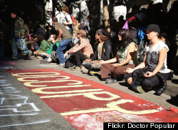 Protestors in San Francisco sit during the Occupy movement's one year anniversary rally.