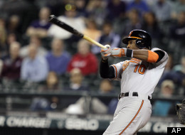 Baltimore Orioles' Adam Jones hits a two-run home run in the 11th inning of a baseball game against the Seattle Mariners, Wednesday, Sept. 19, 2012, in Seattle.