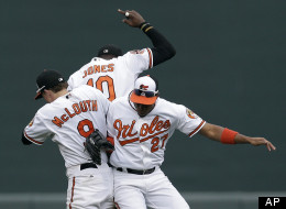 Baltimore Orioles' Nate McLouth, left, Adam Jones and Endy Chavez celebrate after a baseball game against the Boston Red Sox in Baltimore, Sunday, Sept. 30, 2012. Baltimore won 6-3.
