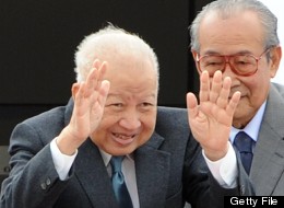 (FILES) Photo dated January 19, 2012 shows Cambodia's former king, Norodom Sihanouk (L) bidding farewell to government officials as he boards a plane before leaving to Beijing at Phnom Penh International airport. (TANG CHHIN SOTHY/AFP/GettyImages)