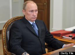 Russia's President Vladimir Putin (L) listens to Central Electoral Commission chairman Vladimir Churov during their meeting in the Novo-Ogaryovo residence, outside Moscow, on October 15, 2012. (ALEXEI NIKOLSKY/AFP/Getty Images)