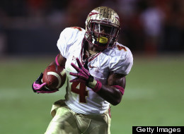 Chris Thompson of the Florida State Seminoles runs with the ball against the North Carolina State Wolfpack during their game at Carter-Finley Stadium on October 6, 2012 in Raleigh, North Carolina.