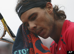 This June 10, 2012 file photo shows Rafael Nadal wiping his face as he plays Serbia's Novak Djokovic during their men's final match in the French Open tennis tournament at Roland Garros stadium in Paris. Nadal still has no timetable for his return from a knee injury.
