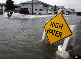 A car goes through the high water as Hurricane Sandy bears down on the east coast, Sunday, Oct. 28, 2012, in Ocean City, Md. Governors from North Carolina, where steady rains were whipped by gusting winds Saturday night, to Connecticut declared states of emergency. Delaware ordered mandatory evacuations for coastal communities by 8 p.m. Sunday. (AP Photo/Alex Brandon)
