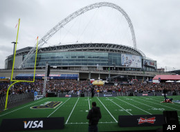 The crowd gathers prior to a NFL football game between St Louis Rams and the New England Patriots at Wembley Stadium, seen in background, in London, Sunday, Oct. 28, 2012.