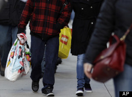 Pedestrians walk along a shopping district on Michigan Avenue in downtown Chicago on Friday, Dec. 23, 2011. (AP Photo/Nam Y. Huh)