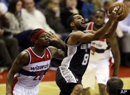 San Antonio Spurs guard Patty Mills, from Australia, shoots as he guarded by Washington Wizards forward Cartier Martin in the second half of an NBA basketball game Monday, Nov. 26, 2012, in Washington. The Spurs won 118-92.