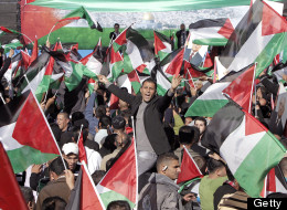 Palestinian flags are waved as crowds wait to hear an address by Palestinian president Mahmud Abbas.