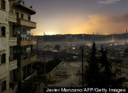 In this Sunday, Dec. 2, 2012, photo, a Free Syrian Army fighter aims his weapon during clashes with government forces in Aleppo, Syria. (AP Photo/Narciso Contreras)