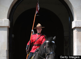 A female member of the Royal Canadian Mounted Police (RCMP) stands guard at Horse Guards Parade in central London, on May 23, 2012, as the RCMP take part in the 'Changing of the Guard' ceremony. Their participation is part of the Queen's Diamond Jubilee celebrations and will also feature women for the first time. (CARL COURT/AFP/GettyImages)