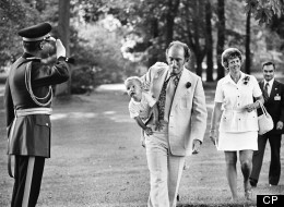 Pierre Trudeau is saluted by RCMP Officer as he carries son Justin to Rideau Hall in 1973. Justin Trudeau teared up when he was presented with a framed copy while visiting Loyalist College. The Canadian Press/ Peter Bregg